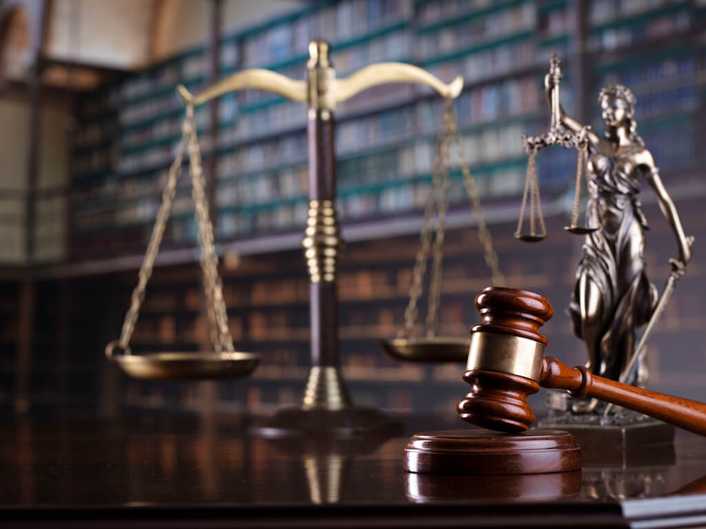 a judicial scale and gavel rest on a table