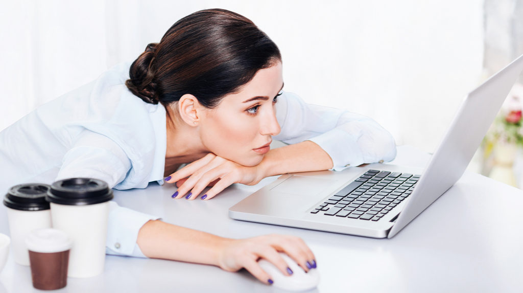 woman looking at laptop sad during social media crisis