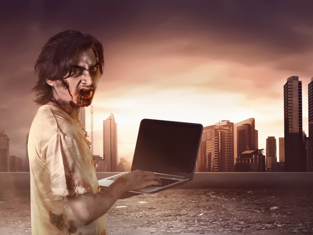 zombie holding laptop walking towards city
